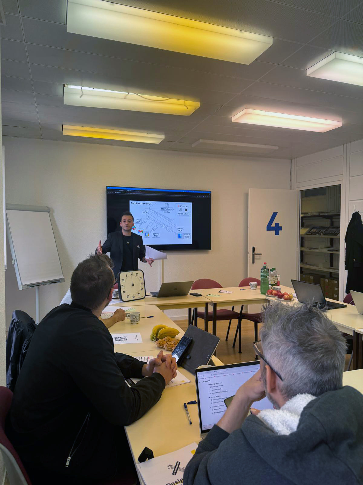 Participants working in small groups during the Agentic AI workshop at Espace Dickens